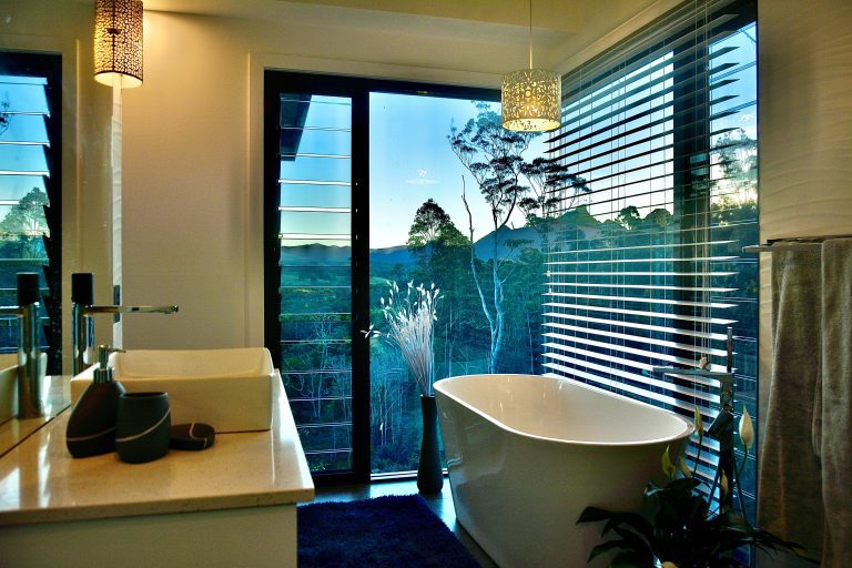 Ensuite bathroom with view over forest and mountains