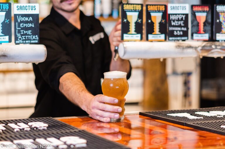 Pouring beers for visitors at Sanctus Brewery
