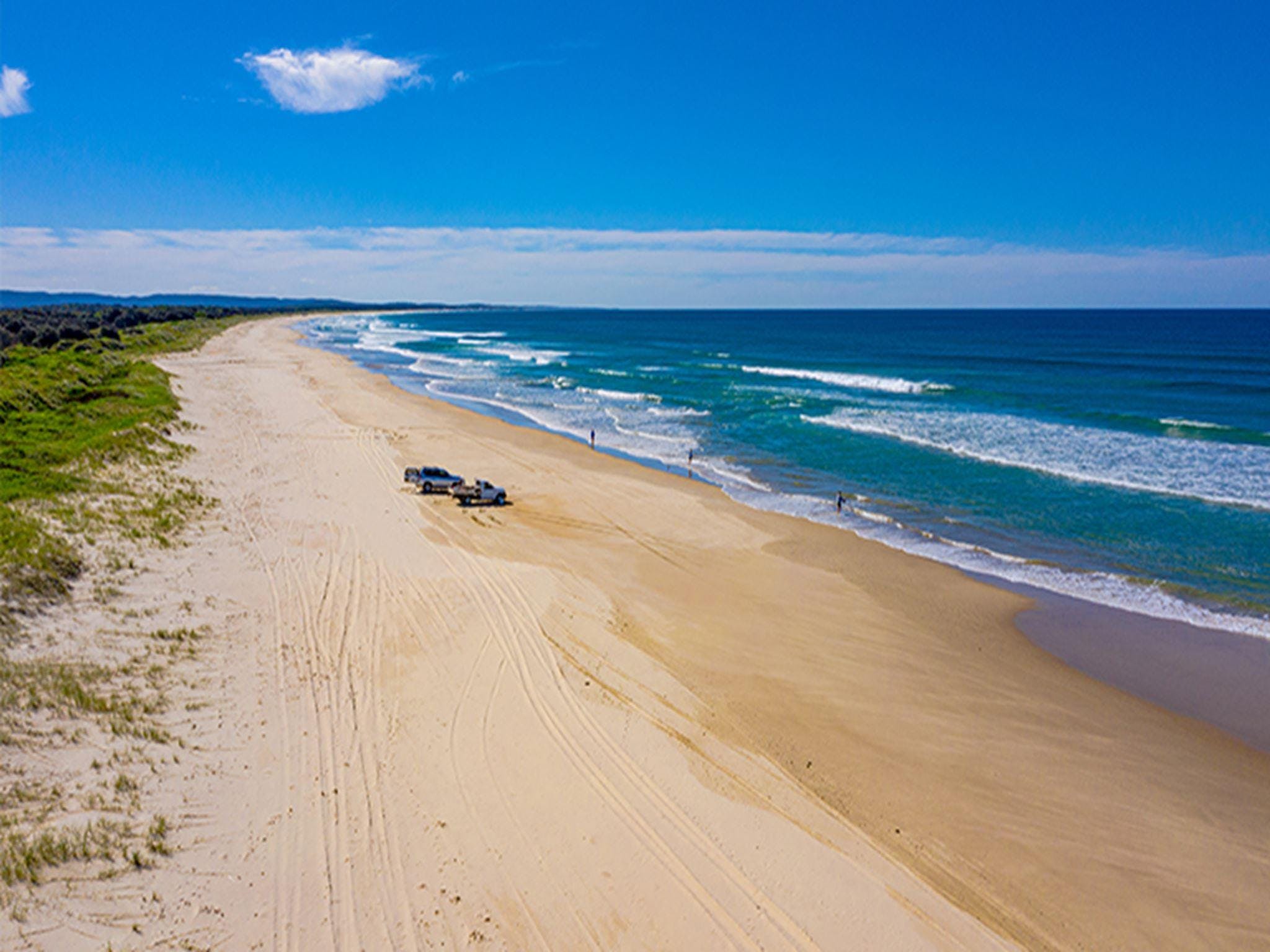 Aerial view of Shark Bay beach coastline with  4WD vehicles in the distance. Photo: Jessica