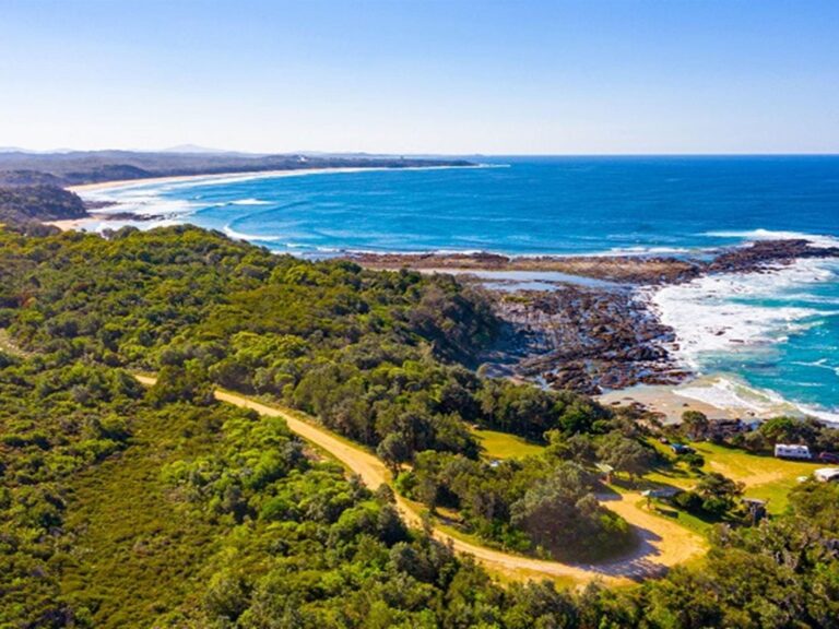 An aerial view of Boorkoom campground with ocean in the background in Yuraygir National Park. Photo: